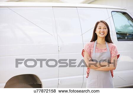 Stock Photo - Woman Wearing Apron Standing In Front Of Van. Fotosearch