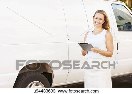 Woman Wearing Apron With Digital Tablet In Front Of Van View Large Photo Image Stock Image - Woman Wearing Apron With Digital Tablet In Front Of Van. Fotosearch