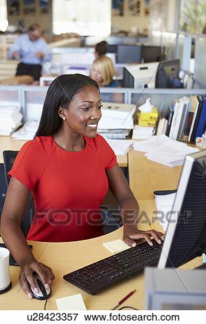 Woman Working At Computer In Modern Office View Large Photo Image Stock Photo - Woman Working At Computer In Modern Office. Fotosearch