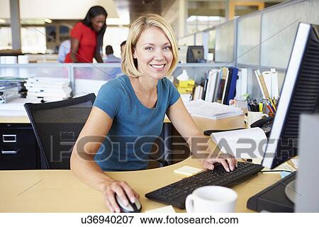 Woman Working At Computer In Modern Office View Large Photo Image Stock Photo - Woman Working At Computer In Modern Office. Fotosearch