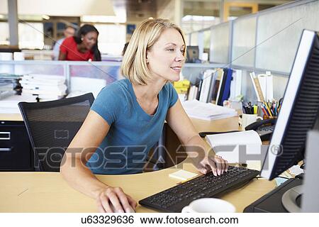 Stock Photograph - Woman Working At Computer In Modern Office. Fotosearch