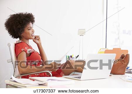 Woman Working At Desk In Design Studio View Large Photo Image Stock Photo - Woman Working At Desk In Design Studio . Fotosearch
