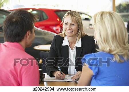 Picture - Woman working in car showroom. Fotosearch