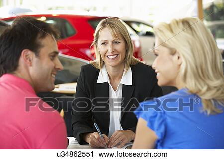 Woman working in car showroom View Large Photo Image Stock Image - Woman working in car showroom. Fotosearch