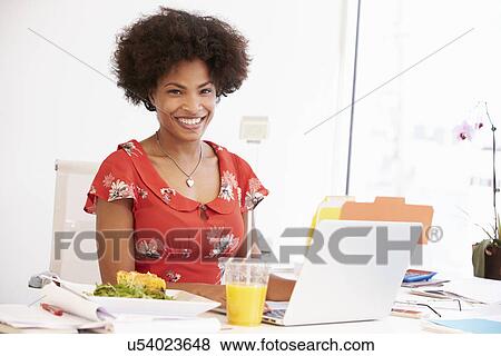 Woman Working In Design Studio Having Lunch At Desk View Large Photo Image Stock Photo - Woman Working In Design Studio Having Lunch At Desk. Fotosearch