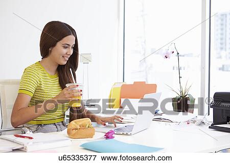 Woman Working In Design Studio Having Lunch At Desk View Large Photo Image Stock Photo - Woman Working In Design Studio Having Lunch At Desk. Fotosearch