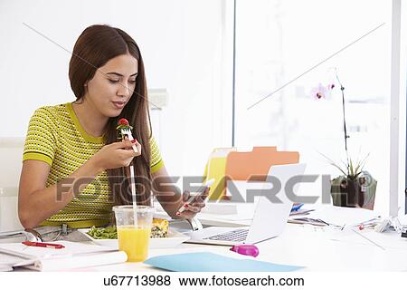 Woman Working In Design Studio Having Lunch At Desk View Large Photo Image Stock Photo - Woman Working In Design Studio Having Lunch At Desk. Fotosearch