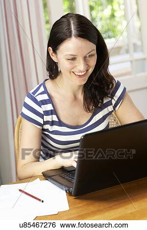 Woman working in home office View Large Photo Image Stock Photograph - Woman working in home office. Fotosearch