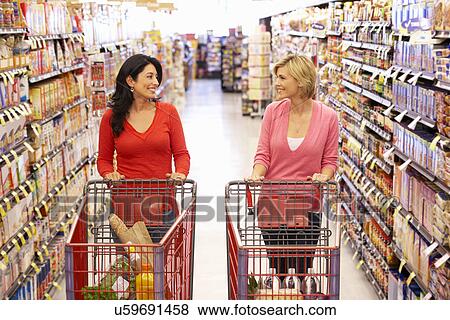 Women shopping in supermarket View Large Photo Image Stock Photo - Women shopping in supermarket. Fotosearch