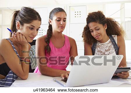 Picture - Women Using Laptop In Modern Office Of Start Up Business. Fotosearch