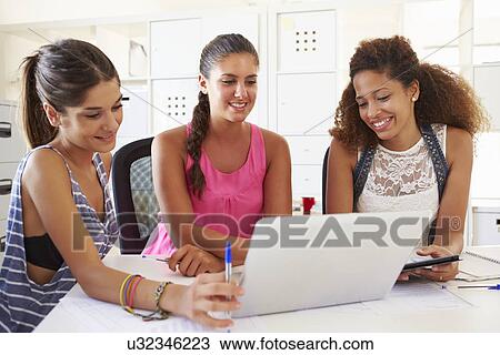 Stock Image - Women Using Laptop In Modern Office Of Start Up Business. Fotosearch