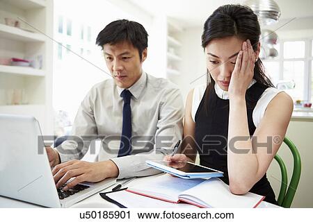 Worried Asian Couple Looking At Personal Finances View Large Photo Image Stock Image - Worried Asian Couple Looking At Personal Finances. Fotosearch