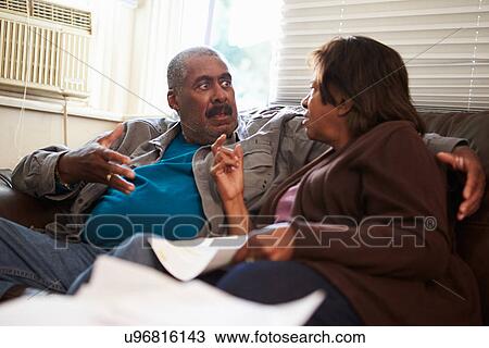 Worried Senior Couple Sitting On Sofa Looking At Bills View Large Photo Image Stock Image - Worried Senior Couple Sitting On Sofa Looking At Bills. Fotosearch
