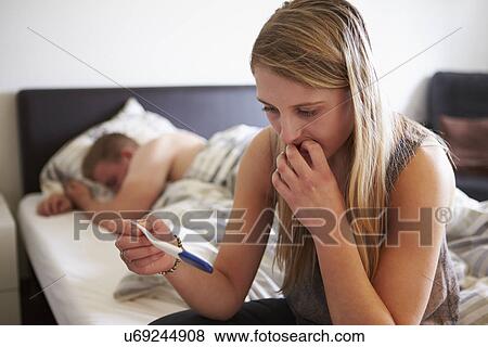 Worried Teenage Girl In Bedroom With Pregnancy Testing Kit View Large Photo Image Stock Photo - Worried Teenage Girl In Bedroom With Pregnancy Testing Kit. Fotosearch