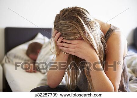 Stock Photo - Worried Teenage Girl In Bedroom With Boyfriend. Fotosearch