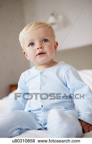 Stock Photo - Young Baby Boy Playing In Bed. Fotosearch
