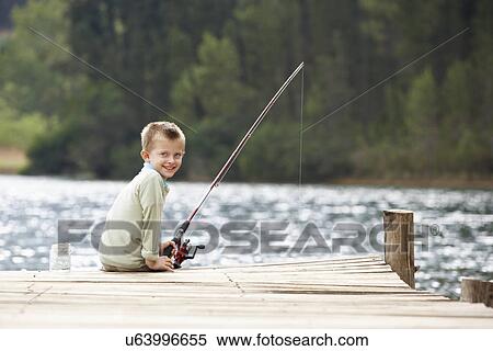 Young boy fishing on a jetty View Large Photo Image Stock Photography - Young boy fishing on a jetty. Fotosearch