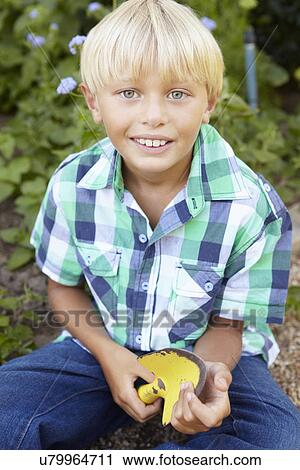 Young boy gardening View Large Photo Image Stock Image - Young boy gardening. Fotosearch
