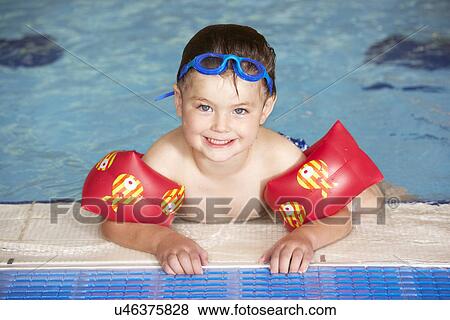 Young boy in swimming pool View Large Photo Image Stock Photo - Young boy in swimming pool. Fotosearch