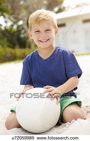 Young Boy Playing Game Of Volleyball In Garden View Large Photo Image Stock Photo - Young Boy Playing Game Of Volleyball In Garden . Fotosearch
