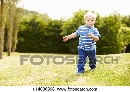 Stock Photo - Young Boy Playing In Summer Garden. Fotosearch
