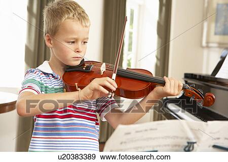 Young boy playing violin at home View Large Photo Image Stock Photo - Young boy playing violin at home. Fotosearch