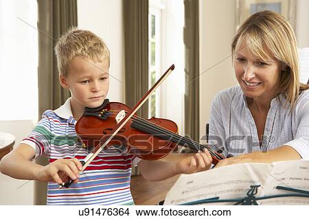 Picture - Young boy playing violin in music lesson. Fotosearch