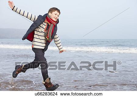 Young Boy Running Along Winter Beach View Large Photo Image Picture - Young Boy Running Along Winter Beach. Fotosearch