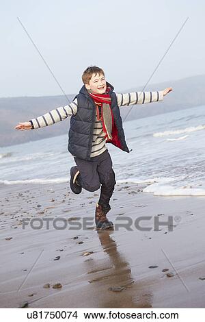 Young Boy Running Along Winter Beach View Large Photo Image Picture - Young Boy Running Along Winter Beach. Fotosearch