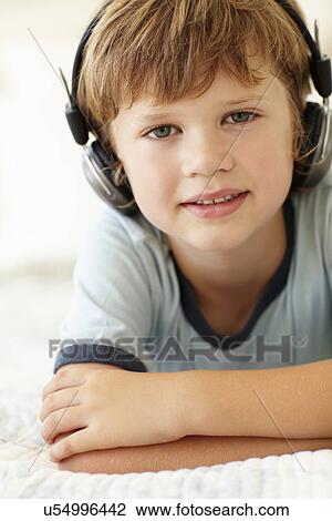 Young boy wearing headphones View Large Photo Image Stock Image - Young boy wearing headphones. Fotosearch
