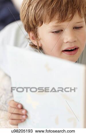 Young boy with book View Large Photo Image Stock Image - Young boy with book. Fotosearch