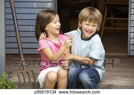 Young brother and sister sitting on veranda View Large Photo Image Picture - Young brother and sister sitting on veranda. Fotosearch