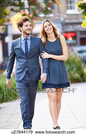 Young Business Couple Walking Through City Park Together View Large Photo Image Stock Photo - Young Business Couple Walking Through City Park Together. Fotosearch
