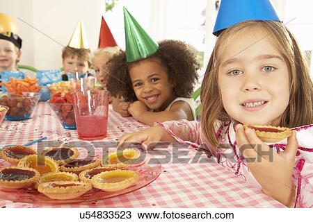 Young children eating jam tarts at birthday party View Large Photo Image Stock Image - Young children eating jam tarts at birthday party. Fotosearch