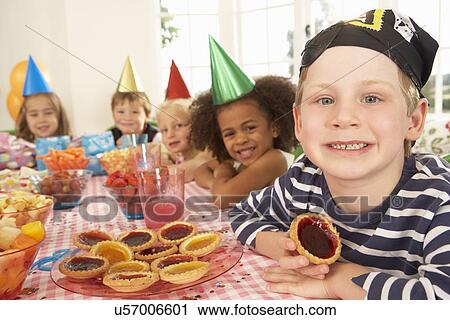 Young children eating jam tarts at birthday party View Large Photo Image Stock Image - Young children eating jam tarts at birthday party. Fotosearch