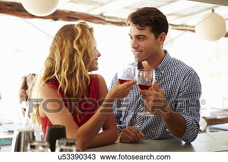 Young Couple Enjoying Drink At Outdoor Bar View Large Photo Image Stock Image - Young Couple Enjoying Drink At Outdoor Bar. Fotosearch