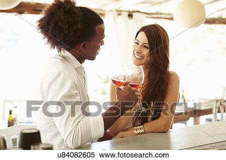 Young Couple Enjoying Drink At Outdoor Bar View Large Photo Image Stock Photography - Young Couple Enjoying Drink At Outdoor Bar. Fotosearch