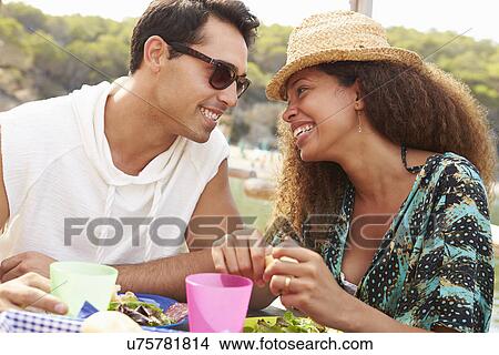 Young Couple Enjoying Lunch Outdoors Together View Large Photo Image Picture - Young Couple Enjoying Lunch Outdoors Together. Fotosearch