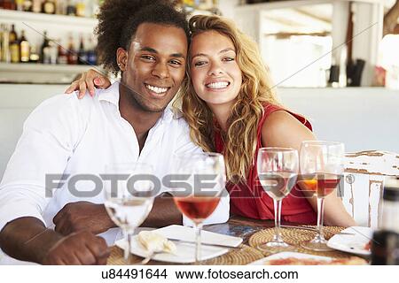 Picture - Young Couple Enjoying Meal In Outdoor Restaurant. Fotosearch