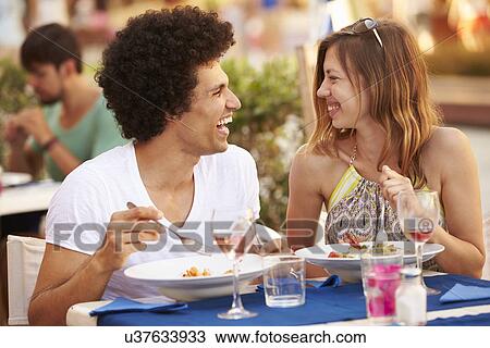 Young Couple Enjoying Meal In Outdoor Restaurant View Large Photo Image Stock Image - Young Couple Enjoying Meal In Outdoor Restaurant. Fotosearch