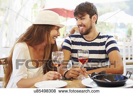 Young Couple Enjoying Meal In Outdoor Restaurant View Large Photo Image Stock Photo - Young Couple Enjoying Meal In Outdoor Restaurant. Fotosearch