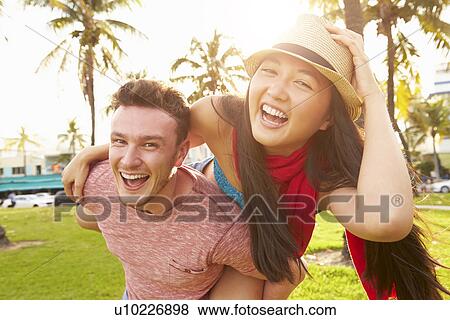 Young Couple Having Fun In Park Together View Large Photo Image Stock Photo - Young Couple Having Fun In Park Together. Fotosearch
