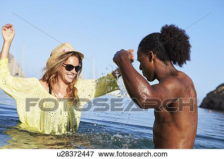 Young Couple Having Fun In Sea Together View Large Photo Image Stock Photo - Young Couple Having Fun In Sea Together. Fotosearch