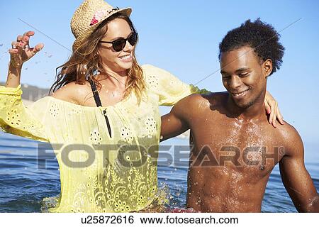 Young Couple Having Fun In Sea Together View Large Photo Image Stock Photograph - Young Couple Having Fun In Sea Together. Fotosearch