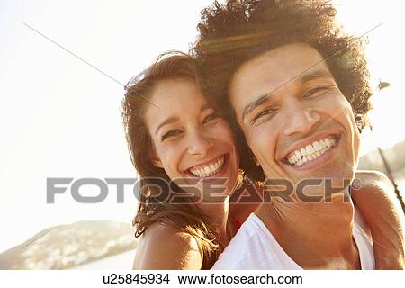 Picture - Young Couple Having Fun On Beach Holiday Together. Fotosearch