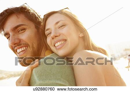 Young Couple Having Fun On Beach Holiday Together View Large Photo Image Stock Image - Young Couple Having Fun On Beach Holiday Together. Fotosearch