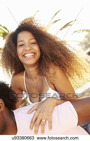 Young Couple Having Fun On Beach Holiday Together View Large Photo Image Stock Image - Young Couple Having Fun On Beach Holiday Together. Fotosearch