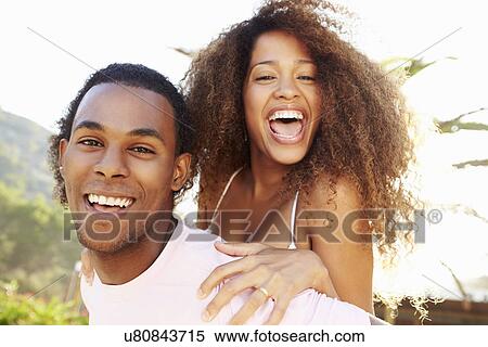 Young Couple Having Fun On Beach Holiday Together View Large Photo Image Stock Photography - Young Couple Having Fun On Beach Holiday Together. Fotosearch