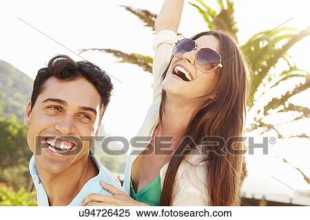 Young Couple Having Fun On Beach Holiday Together View Large Photo Image Stock Photography - Young Couple Having Fun On Beach Holiday Together. Fotosearch