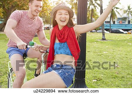 Young Couple Having Fun On Bicycle Ride View Large Photo Image Picture - Young Couple Having Fun On Bicycle Ride. Fotosearch
